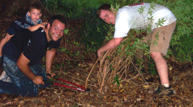 Josh, Silas, and I, hacking up some bushes.