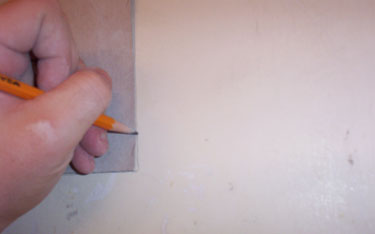 5-Marking where to remove paper from the wall.
