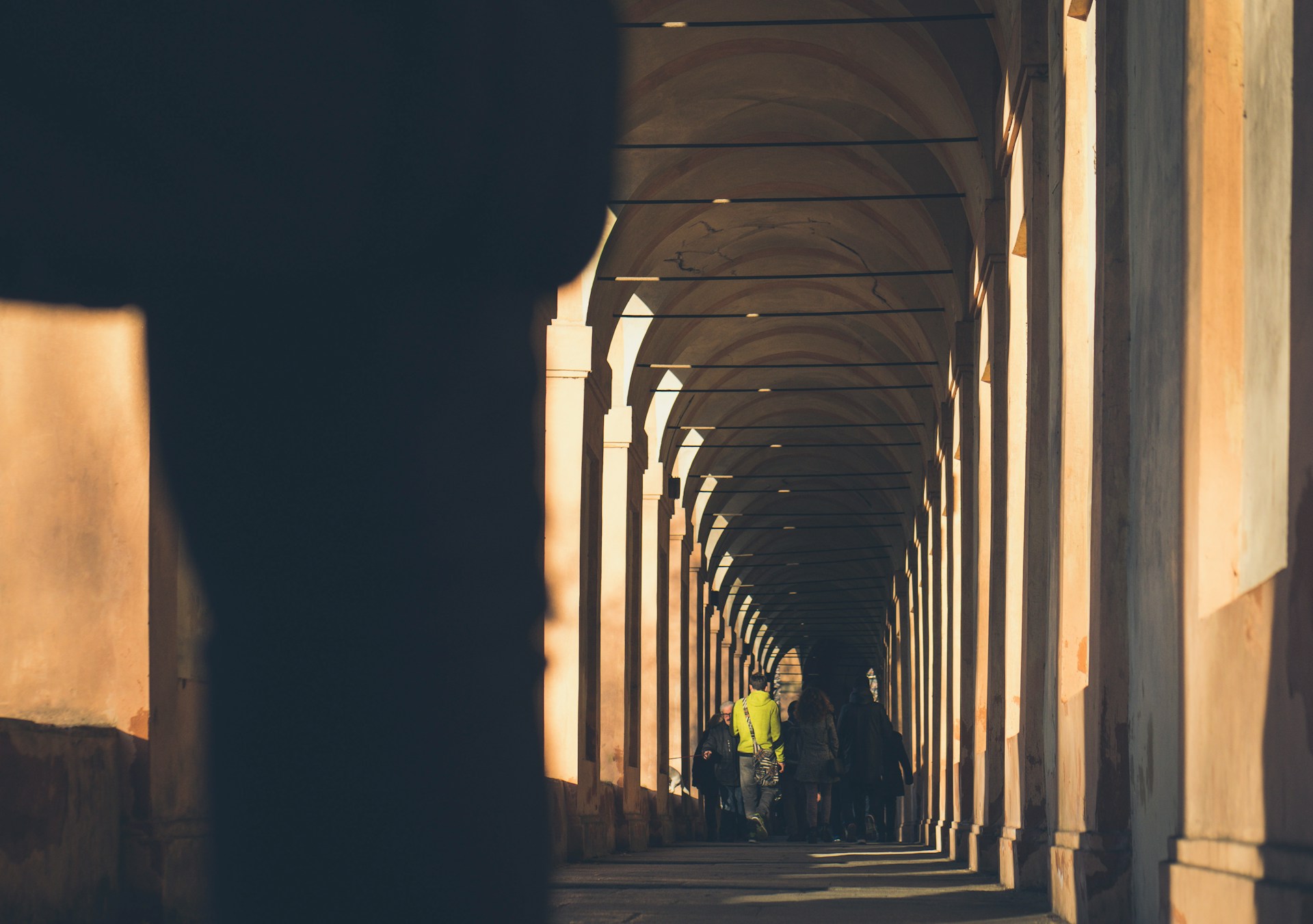 Bologna porticoes people walking arco del meloncello
